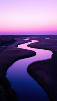 A river runs through a marsh at sunset photo