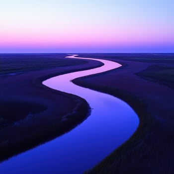 A river runs through a marsh at sunset photo
