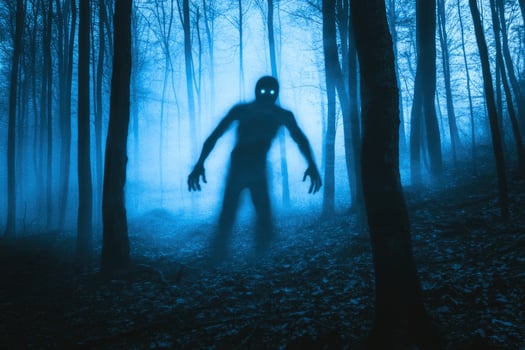 Eerie Forest Creature Apparition in Blue Mist Creates Chilling Halloween Scene photo