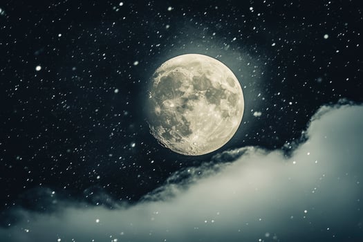 Full Moon Shining Above Clouds in Night Sky with Falling Snow photo
