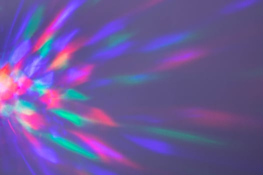 Beautiful multicolored geometric highlights pink blue yellow on a lilac background. photo
