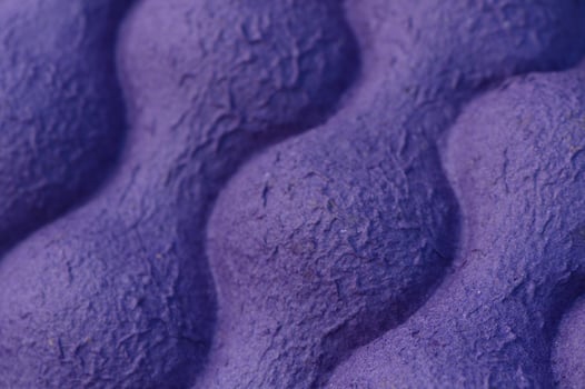 Exploring the intricate textures of a vibrant purple surface in close detail during daylight photo