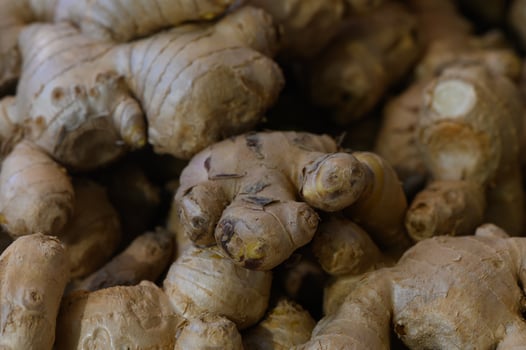 Fresh ginger roots piled together at a local market showcasing nature's flavor and health benefits photo