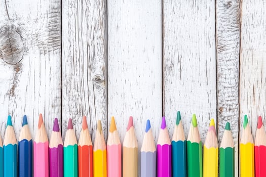 Vibrant Colored Pencils Arranged Neatly on a Bright White Wooden Background photo