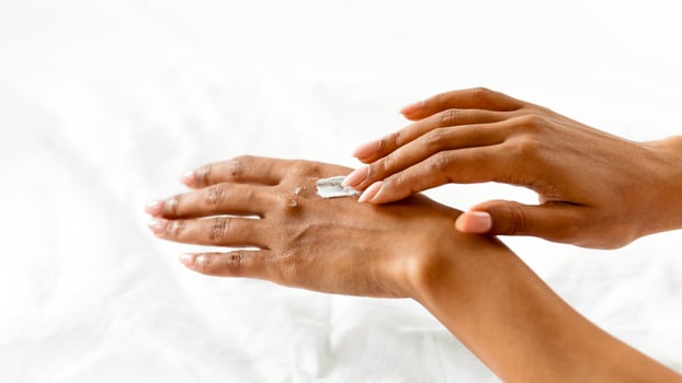 Dry Hands Prevention. Black Female Applying Cream For Skin Moisturising, Cropped Image, Panorama With Copy Space photo