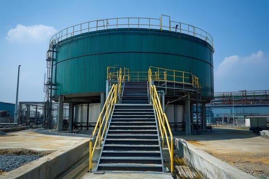 Large green industrial tank with metal staircase in chemical plant photo