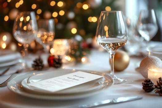 Christmas dinner table setting menu with wine glasses and festive decorations photo
