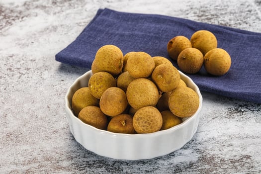 A bowl of kiwis on a table photo