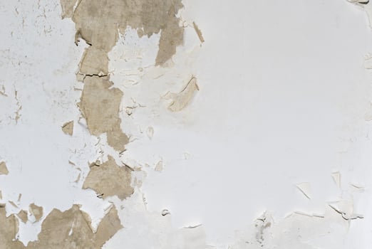 old wall with peeling white paint. background photo