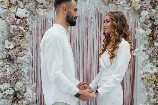 Holding by, the hands. A young groom with his bride in a white dress. Wedding conception photo