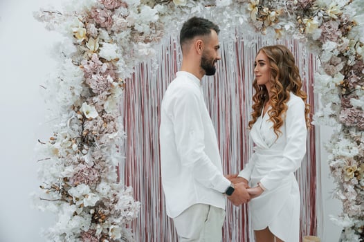 Holding ,by the hands. A young groom with his bride in a white dress. Wedding conception photo