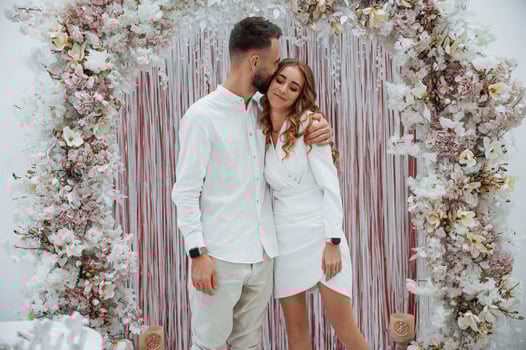 A young groom with his bride in a white dress. Wedding conception photo