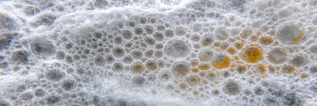 Abstract close-up of white and yellow mold with bubble-like patterns photo