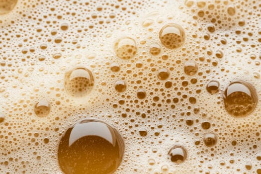 A close up of a glass of beer with bubbles photo