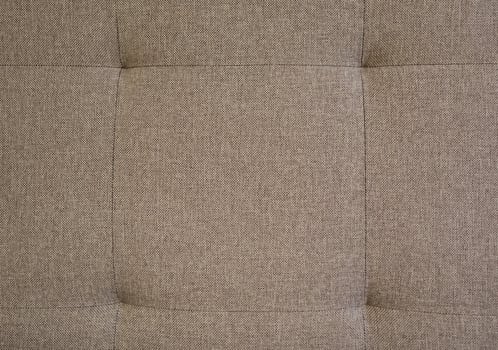 This elegant retro tufted brown fabric background features unique button accents that enhance its vintage charm. Ideal for interior design and upholstery, it adds warmth and comfort to any space. photo