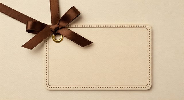 Blank card with brown ribbon and bow on beige background photo