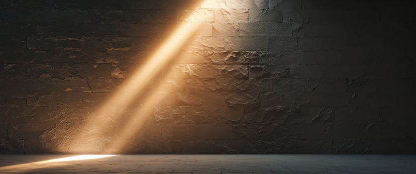 A room with a stone wall and a light shining through it photo