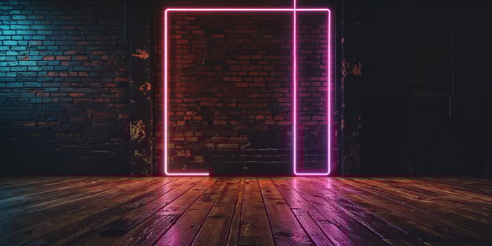 A neon sign in a dark room with a wooden floor photo