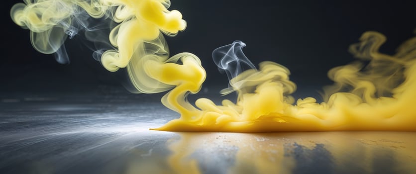 Yellow smoke and liquid on a black background photo