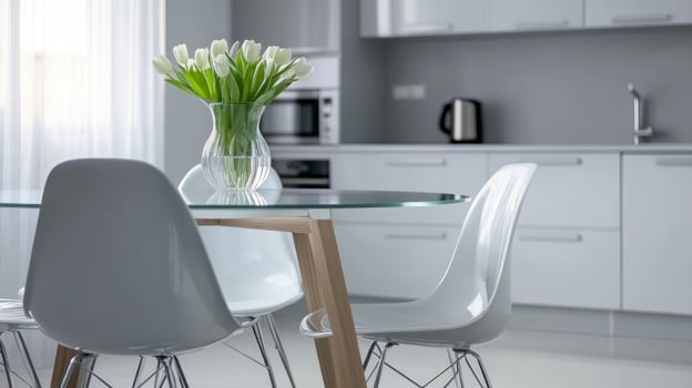 A modern kitchen with white chairs and a vase of flowers photo