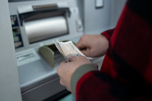 Close-Up of a Man Taking Money from an ATM, Cash Withdrawal photo