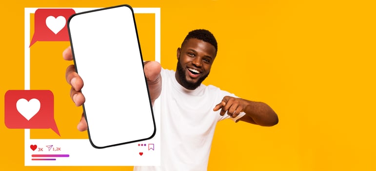 An influencer displays a smartphone with a blank screen, emphasizing social media interaction. The background is vibrant yellow, creating an inviting atmosphere for digital communication. photo
