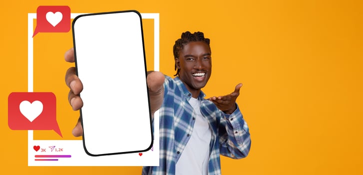 An influencer shares excitement while holding a smartphone against a bright background. photo