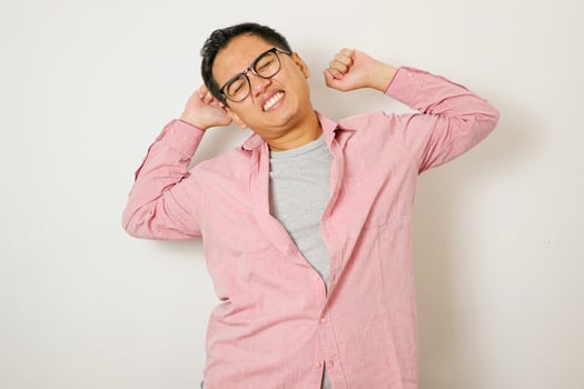 Spine problems. Portrait of young asian man in casual white t-shirt holding his back, having sudden lower back pain, pinched nerve or kidney inflammation. photo