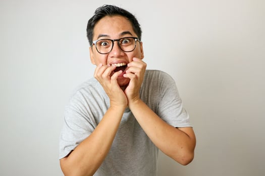 Shocked and surprised face of asian man jumping out isolated on white. photo