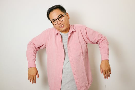 Asian man raises both hands and shoulders because he is lazy photo