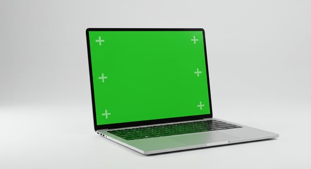 Laptop with green screen on white background photo