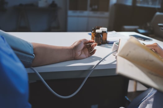 A doctor is checking the blood pressure of a patient photo