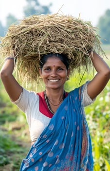 Indian woman carrying hay on head rural background photo
