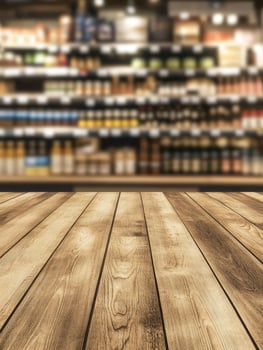 Wooden Floor in Front of Blurred Grocery Store Shelf Background photo