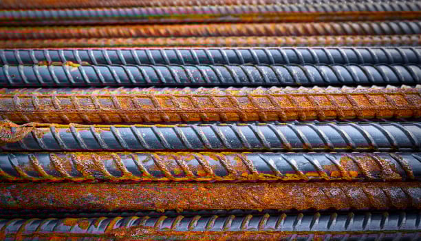 Rusted Steel Bars Stacked in Construction Yard During Daylight With Textures Emphasized photo