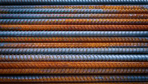 Rusty Steel Bars Stacked Neatly on Construction Site Showing Signs of Wear Over Time During Daylight Hours photo