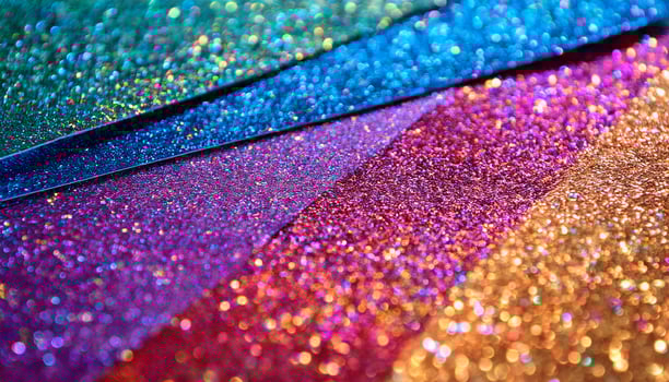 Vibrant Glitter Sheets Shining With Colorful Hues in Creative Workspace photo