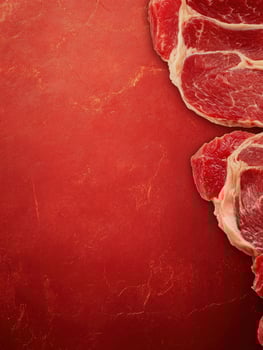 Raw Beef Steaks on Red Background for Food Photography and Recipes photo