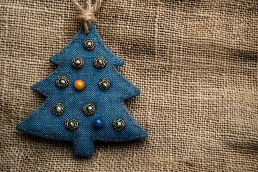 Festive Christmas Tree Ornament on Burlap Background for Holiday Decor photo
