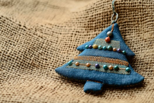 Handmade Christmas Tree Ornament Decoration Crafted From Fabric on Burlap photo
