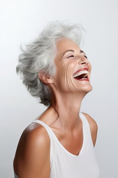Woman with gray short hair laughs photo