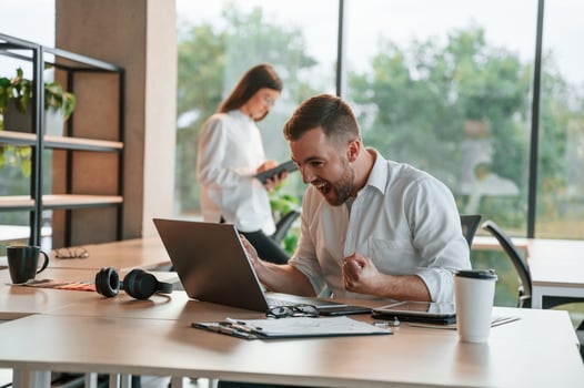 Successful deal. Using laptop.. Man and woman are working in the modern office together photo