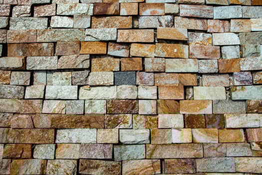 Close up of a wall made of natural stones. Abstract background. photo