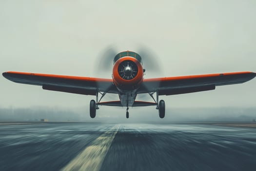 Vintage propeller airplane takes to the skies amidst a misty dawn at a remote airstrip photo