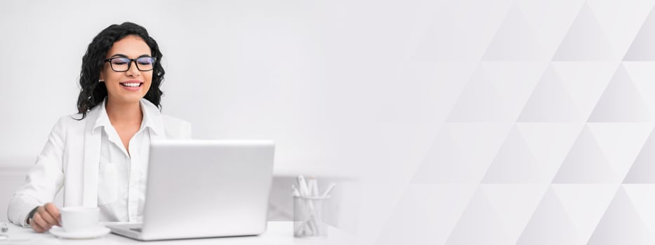 Happy Mexican Businesswoman Making Call To Family Using Laptop During Coffee Break At Work. Free space photo