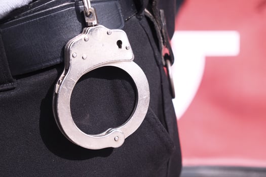 Police officer wearing handcuffs during a law enforcement activity photo