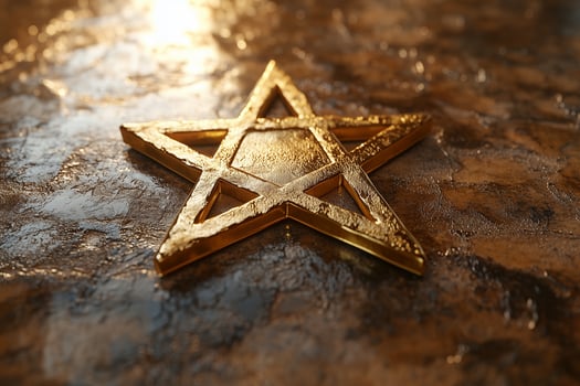 Golden Star of David on textured background with warm lighting and copy space for text photo