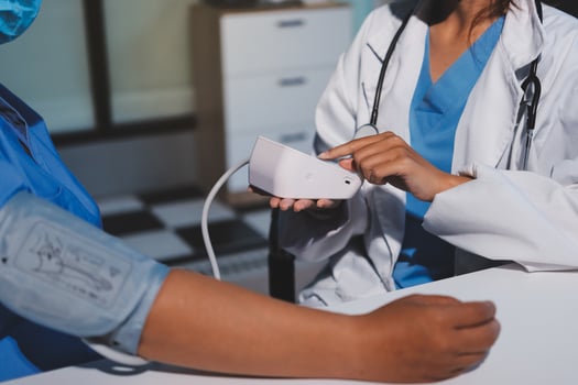 A doctor checking the blood pressure of a patient photo
