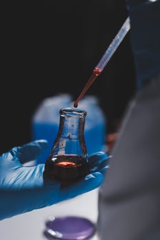 A person holding a test tube with liquid in it photo