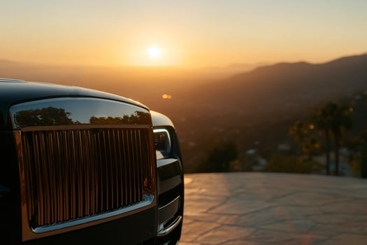 The sun is setting behind a rolls royce photo
